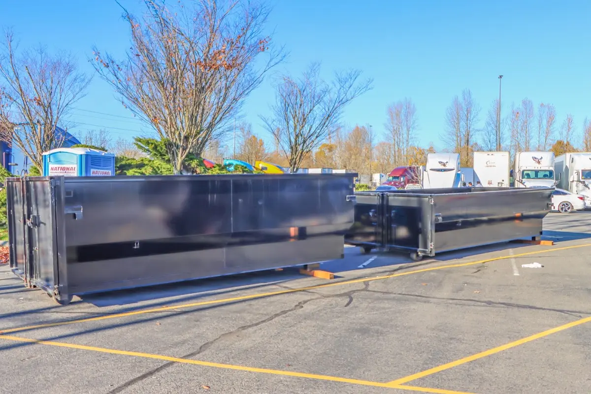 Professional dumpster rental service with roll-off container on residential driveway in New Prague